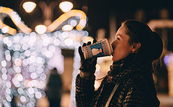 woman drinking a hot beverage